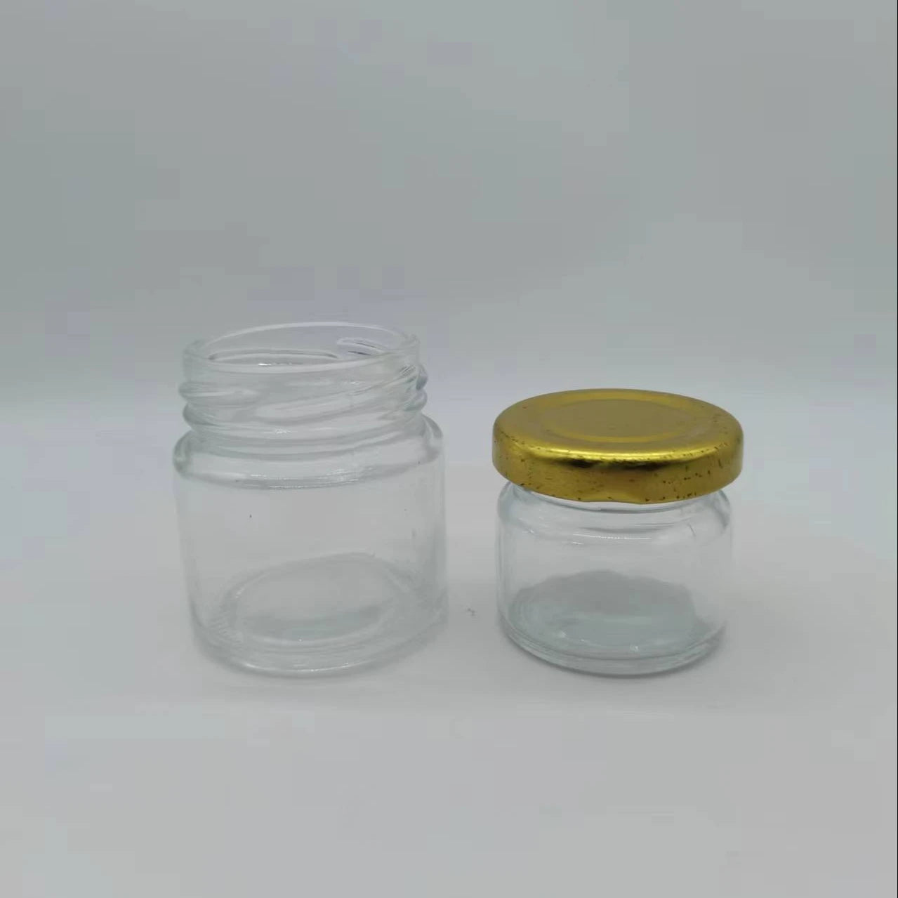 Hot Sale Luxury 20ml-100ml Hexagon Glass Bottles with Gold/Silver Metal Cap for Food Storage