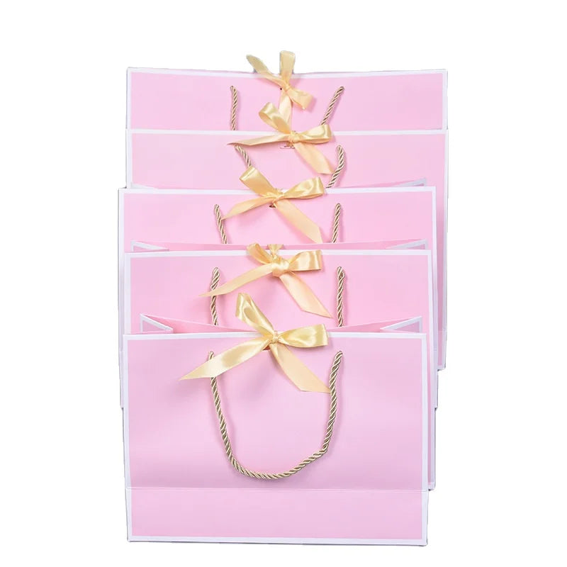 Boutique Reusable Pink Luxury Jewelry Gift Shopping Paperboard Bags with Ribbon Handles and Bow Tie Recycled Materials