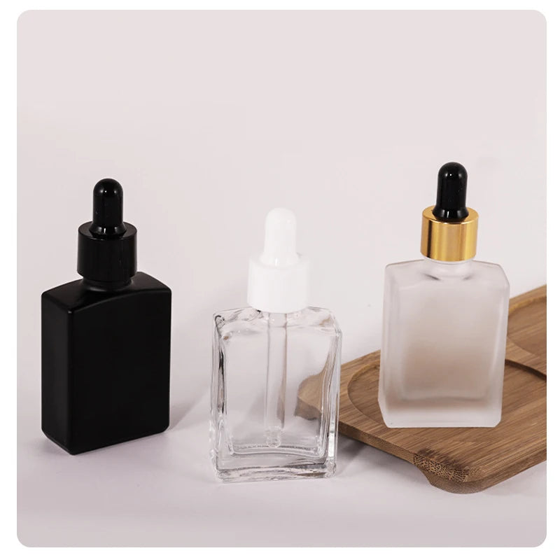 In Stock 15ml 30ml 50ml 100ml Square Flat Clear/Frosted/Black Glass Dropper Bottle with Golden Screw Collar