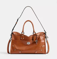 Bolso de mano COACH Rider 38 Satchel 2 vías cuero esmaltado ámbar marrón...
