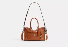 Bolso de hombro COACH Rhyder Satchel 24 CFN69 de cuero esmaltado marrón ámbar...