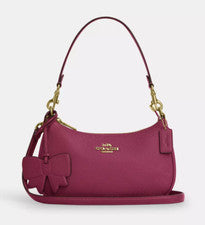 Bolso de hombro Coach para mujer de cuero Teri dorado/rosa con dije de lazo (CY654) - NUEVO CON ETIQUETAS