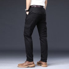 Pantalones cómodos sueltos elásticos elásticos con herramientas de color liso de moda para hombre