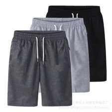 Pantalones deportivos finos de cinco puntos sueltos informales de moda de color liso para hombre