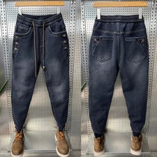Pantalones de mezclilla desgastados ajustados harén pantalones sueltos de moda para hombre con cordón