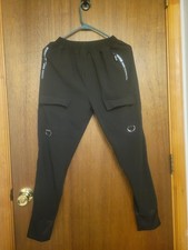 Pantalones de chándal Staye Professional negros cargo bolsillos con cremallera estilo ropa técnica