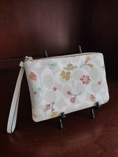 Muñequera con cremallera en lona blanca tiza con estampado floral místico