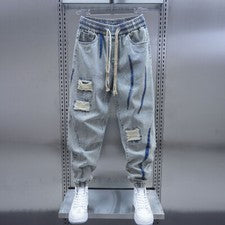 Moda Para Hombres Pantalones de mezclilla ajustados Agujeros rasgados Sueltos Harén Cordón Informal
