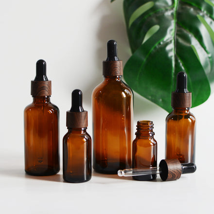 Wholesale 5/10/15/20/30/50/100ml Amber Round Shoulder Glass Dropper Bottle with Black Woodgrain Cap for Serum Skincare Packaging