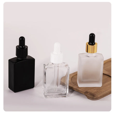 In Stock 15ml 30ml 50ml 100ml Square Flat Clear/Frosted/Black Glass Dropper Bottle with Golden Screw Collar